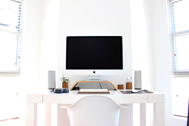 hands connecting laptop to monitor using usb-c dock and organized cables on desk